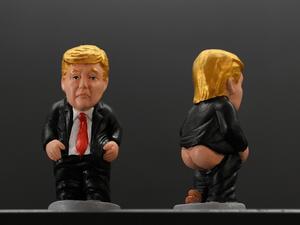 A picture shows typical Catalan ceramic figurines called "caganers" (poopies) depicting US President Donald Trump in Barcelona on October 22, 2022. Statuettes of well-known people defecating are a strong Christmas tradition in Catalonia, dating back to the 18th century as Catalans hide "caganers" in Christmas Nativity scenes and invite friends to find them. LLUIS GENE / AFP