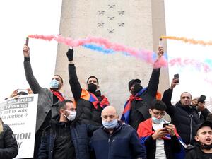 Men demonstrate with fumigenes during a rally called by the Coordination Council of Armenian Organizations of France (CCAF) to protest against conflict in Nagorno-Karabakh, in Paris, on October 25, 2020. Alain JOCARD / AFP