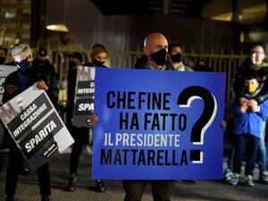 A protestor holds a banner reading "Where is president Mattarella" as owners of pubs, bars, restaurant and the activities affected by the measures to contain the Coronavirus COVID-19 as they protest in front of the Regione Lazio headquarters in Rome on October 28, 2020. Filippo MONTEFORTE / AFP