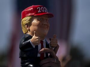 A supporter waves a Donald Trump figurine during a Make America Great Again campaign rally in Tampa, Florida on October 29, 2020. Ricardo ARDUENGO / AFP