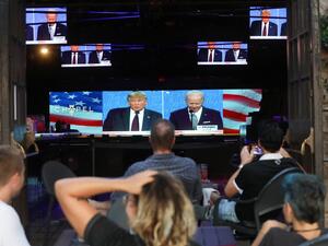 People sit and watch a broadcast of the first debate between President Donald Trump and Democratic presidential nominee Joe Biden at The Abbey, with socially distanced outdoor seating, on September 29, 2020 in West Hollywood, California. The debate being held in Cleveland, Ohio is the first of three scheduled debates between Trump and Biden. Mario Tama/Getty Images/AFP MARIO TAMA / GETTY IMAGES NORTH AMERICA / Getty Images via AFP
