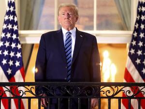 U.S. President Donald Trump stands on the Truman Balcony after returning to the White House from Walter Reed National Military Medical Center on October 05, 2020 in Washington, DC. Trump spent three days hospitalized for coronavirus. Win McNamee/Getty Images/AFP
