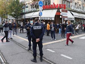 French policemen stand guard a street after a knife attack in Nice. (AFP)
