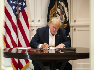 Donald Trump was photographed at Walter Reed Medical Center appearing to sign a blank piece of paper in an attempt to show he was still working. (Twitter)
