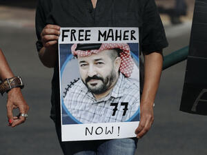 Israeli activists lift a placard bearing the picture of Palestinian administrative detainee Maher Al-Akhras during a demonstration calling for his release on October 11, 2020 [AHMAD GHARABLI/AFP via Getty Images]