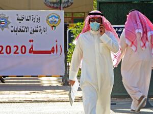 A candidate for the upcoming Kuwaiti parliamentary election talks on the phone at the Department of Elections in Kuwait City on the first day of candidate registration, on October 26, 2020. YASSER AL-ZAYYAT / AFP 