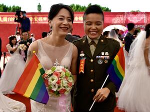Newly-wedded same-sex couple Yi Wang (R) and Yumi Meng pose for a photograph during a mass wedding at Taiwan's Army Command Headquarters in Taoyuan on October 30, 2020, where two Taiwanese soldiers and their civilian same-sex partners tied the knot marking another gay rights landmark in Asia. Sam Yeh / AFP