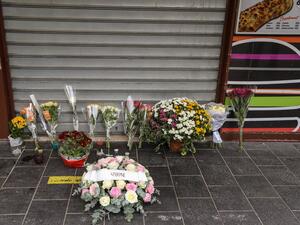 Flowers have been laid outside the restaurant where Brazilian Simone Barreto Silva took refuge after being stabbed several times but died of her wounds there, near the Notre-Dame de l'Assomption Basilica in Nice on October 31, 2020. (AFP)