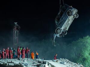 A crane lifhts the wreckage of a car as rescue workers search for survivors in the debris of a collapsed building on November 1, 2020 in the Bayrakli district of Izmir, after a powerful earthquake struck Turkey's western coast and parts of Greece. AFP