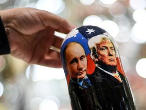 A vendor shows a traditional Russian wooden nesting doll, Matryoshka doll, depicting Russia's President Vladimir Putin and US President and Republican presidential nominee Donald Trump at a gift shop in central Moscow on November 3, 2020. Kirill KUDRYAVTSEV / AFP