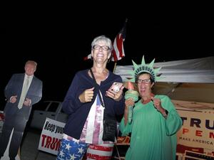 Supporters of US President Donald Trump, Carol Sievers (L) and Pamela Morgan, cheer near a Trump cardboard cutout at Bob Ruud Community Center on Election Day, November 3, 2020, in Pahrump, Nevada. Ronda Churchill / AFP