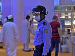 An Emirati policeman uses a smart helmet to detect people's temperature as a tool to fight the spread of the Covid-19 coronavirus among the visitors of the the Sharjah International Book Fair in Sharjah, northeast of Dubai, on November 4, 2020.   Karim SAHIB / AFP
