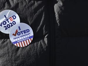 A member of the "Democrats Abroad" organisation wears an "I voted 2020" sticker during a demonstration near the US embassy in Berlin on November 4, 2020, as votes' counting continues in the current presidential election. The US election was plunged into chaos early Wednesday November 4, 2020, as President Donald Trump prematurely declared victory and sought Supreme Court intervention to stop vote-counting -- even as his Democratic rival Joe Biden voiced confidence in his own chances. John MACDOUGALL / AFP