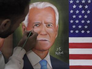 A painter gives the final touches to a painting depicting newly elected US President Joe Biden, in Amritsar on November 8, 2020. NARINDER NANU / AFP