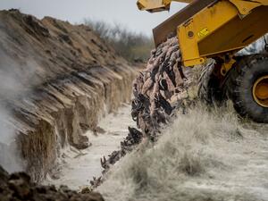A truck unloads dead mink into a ditch as members of Danish health authorities assisted by members of the Danish Armed Forces bury the animals in a military area near Holstebro, Denmark on November 9, 2020. Morten Stricker / Ritzau Scanpix / AFP