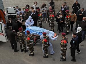 The body of Palestine Liberation Organisation secretary general and chief negotiator Saeb Erekat arrives at a hospital in the West Bank city of Ramallah on November 10, 2020. (AFP/File)