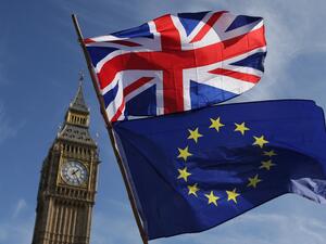  In this file picture taken on March 25, 2017 an EU flag and a Union flag held by a demonstrator is seen with Elizabeth Tower (Big Ben) and the Houses of Parliament as marchers taking part in an anti-Brexit, pro-European Union (EU) enter Parliament Square in central London, ahead of the British government's planned triggering of Article 50 next week. Daniel LEAL-OLIVAS / AFP