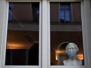 A bust of the former composer Ludwig van Beethoven is decorated with a protective mask in a store window in Weimar, Germany, on November 14, 2020, amid the ongoing novel coronavirus Covid-19 pandemic. Christof STACHE / AFP