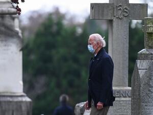 US President-elect Joe Biden walks past tombstones after leaving the St. Joseph on the Brandywine Catholic Church after attending Mass in Wilmington, Delaware on November 15, 2020. AFP