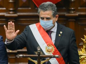In this file picture taken on November 10, 2020 the head of the Peruvian Congress, Manuel Merino (R), waves after being sworn in as interim president in Lima, a day after the Congress voted to impeach and oust President Martin Vizcarra over corruption allegations. Peru's President Manuel Merino resigned on November 15, 2020, just five days after taking office, sparking wild street celebrations in the capital Lima after protests against his rule. Cesar Von BANCELS / AFP