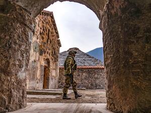 A Russian peacekeeper walks past along a yard of the 12th-13th century Orthodox Dadivank Monastery, outside the town of Kalbajar on November 16, 2020, after the monastery was put under their protection as part of the peace agreement putting an end to the military conflict between Armenia and Azerbaijan. (AFP/File)