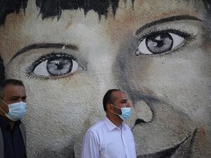 Palestinian UNRWA emplyees, mask-clad due to the COVID-19 coronavirus pandemic, protest outside the headquarters of the United Nations Relief and Works Agency for Palestine Refugees in the Near East (UNRWA) in Gaza City on November 17, 2020 against the reduction of their salaries.  AFP