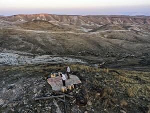 This picture taken on November 17, 2020 shows an aerial view of Orthodox Jewish men performing a noon prayer atop a hilltop near the Israeli settlement of Ma'ale Rehav'am in the occupied West Bank, south of Bethlehem. MENAHEM KAHANA / AFP