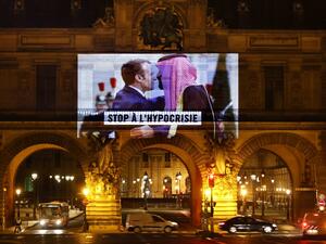 This picture taken early on November 19, 2020, shows a projection on the Louvre Museum in Paris by Amnesty International members depicting French President Emmanuel Macron greeting Saudi Crown Prince Mohammed bin Salman and reading "Stop hypocrisy", ahead of the upcoming virtual G20 summit. THOMAS COEX / AFP