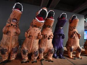 Protesters dressed in dinosaur costumes -- which pro-democracy activists said represents the older generation of Thai politicians -- take part in a 'Bad Student' rally in Bangkok on November 21, 2020. Mladen ANTONOV / AFP