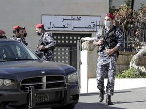 Policemen stand guard outside a detention centre from which prisoners had fled earlier in Baabda, east of Lebanon's capital Beirut, on November 21, 2020. At least 69 people fled a detention centre in Lebanon on November 21, including five who later died in a car accident on a nearby road, sparking a wide-reaching manhunt, police said. ANWAR AMRO / AFP