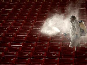 A member of the Guadalajara staff disinfects the stands before the start of the repechage football match of the Mexican Apertura tournament between Guadalajara and Necaxa at the Akron stadium in Guadalajara, Jalisco state, Mexico, on November 21, 2020, during the COVID-19 coronavirus pandemic. Ulises Ruiz / AFP