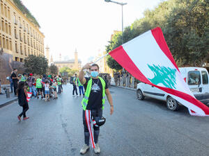 A Lebanese protester waves the national flag during a recent demonstration in Beirut. (AFP)