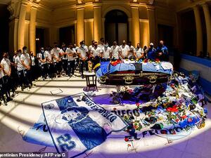 Argentina's football players pay tribute to Maradona as scarves, flags and football jerseys are piled up around the coffin draped in the national flag at his wake in the presidential palace on Thursday. (AFP/File)