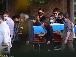 The coffin of Maradona is carried by his family and friends at the Jardin Bella Vista cemetery in Buenos Aires province on November 26. AFP