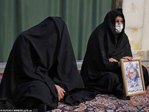 Mourners are seen during the funeral procession of Iran's assassinated top nuclear scientist Mohsen Fakhrizadeh at Imam Reza Shrine. (AFP)