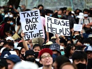 Anti-government protesters hold up signs during a rally at Democracy Monument in Bangkok on August 16, 2020. (AFP)