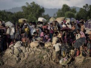 This file photo taken on October 10, 2017 shows Rohingya refugees fleeing from Myanmar arrive at the Naf river in Whaikyang, Bangladesh border.//AFP