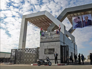 Portraits of Egyptian President Abdel Fattah al-Sisi and Palestinian leader Mahmud Abbas hang at the Rafah border crossing with Egypt. (Said Khatib, AFP )