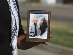 A supporter of the Iran-backed Hashed al-Shaabi (Popular Mobilisation) paramilitary forces carries a frame with pictures of slain Iranian commander Qassem Soleimani (L), Iraqi paramilitary commander Abu Mahdi Al-Muhandis (R), the late founder of the Islamic Republic Ayatollah Ruhollah Khomeini and its Supreme Leader Ayatollah Ali Khamenei, in Baghdad's Karrada neighbourhood on October 17, 2020. AHMAD AL-RUBAYE / AFP