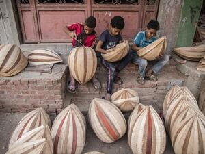Children work on Arabian Ouds at a workshop belonging to Khaled Azzouz, a veteran oud-maker at the al-Marg district on the outskirts of the Egyptian capital Cairo on October 26, 2020. Azzouz said he had observed "unprecedented interest" in the out during the global health pandemic. Occasionally, children from the neighbourhood earn pocket money by doing odd jobs at the workshop, such as removing staples from the unfinished oud bodies, Azzouz said. Khaled DESOUKI / AFP