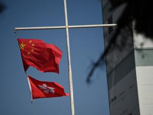 The Chinese (top) and Hong Kong flags flutter in Hong Kong on December 5, 2020. PETER PARKS / AFP
