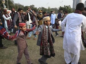 People wearing traditional dresses dance to celebrate the Sindhi Cultural Day in Islamabad on December 6, 2020. Aamir QURESHI / AFP