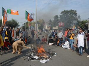 Bharatiya Janata Party supporters block a road during a 12-hour general strike in North Bengal called by BJP to protest against the West Bengal state government in Siliguri on December 8, 2020. Diptendu DUTTA / AFP