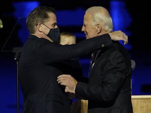 US President-elect Joe Biden (R) embraces his son Hunter Biden (L) on stage after delivering remarks in Wilmington, Delaware. US President-elect Joe Biden's son Hunter, a frequent target of Republican attacks during the 2020 election campaign, said December 9, 2020, he is under investigation for potential tax violations. Andrew Harnik / POOL / AFP