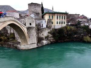 A photo shows deserted streets with scarse passers by in historical core of the Southern-Bosnian town of Mostar, on December 7, 2020. Mostar is the only Bosnian city that has not held local elections in 12 years. Split into Croat and Bosniak zones by the Dayton Peace Agreement, which ended Bosnia's war 25 years ago, the town is a symbol of the broken politics that has haunted the Balkan state ever since. With two nationalist parties in power and unable to agree on voting rules, Mostar has not held local ele