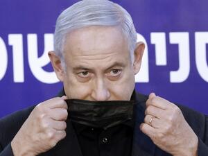 Israeli Prime Minister Benjamin Netanyahu wears a protective mask after receiving a coronavirus vaccine at the Sheba Medical Center, the country's largest hospital, in Ramat Gan near the coastal city of Tel Aviv, on December 19, 2020. Netanyahu, 71, and Israel's health minister were injected with the Pfizer-BioNTech vaccine live on TV at Sheba Medical Center. Each recipient must receive a booster shot in three weeks for optimal protection from the novel coronavirus. JACK GUEZ / AFP