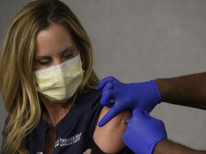 A front-line health care worker receives their first dose of the Pfizer-BioNTech Covid-19 vaccine at a vaccination site at Torrance Memorial Medical Center on December 19, 2020 in Torrance, California. The vaccine brings hope for health care workers as the Los Angeles County Department of Public Health reports over 600,000 positive COVID-19 cases in the county. Patrick T. Fallon / AFP