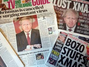 An arrangement of UK daily newspapers photographed as an illustration in Liverpool on December 20, 2020, shows front page headlines reporting on the story of Britain's Prime Minister Boris Johnson introducing new tougher coronavirus COVID-19 restrictions for London and the South East of England, cancelling Christmas gatherings for those in the new 'tier 4' category. British Prime Minister Boris Johnson on Saturday announced a "stay at home" order for London and southeast England to slow a new coronavirus st