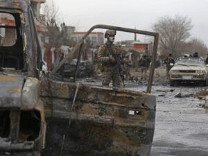 A member of Afghan security force stands guard at the site of an attack in Kabul on December 20, 2020. A car bomb targeting an Afghan lawmaker killed nine people and wounded more than a dozen in Kabul on December 20, officials said, the latest attack to rock the capital. Zakeria HASHIMI / AFP
