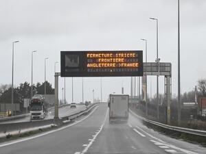 A truck drives by a sign indicating the border closure from England to France on a road in Calais on December 21, 2020 as countries worldwide banned arrivals from the UK on december 20 over a new highly infectious coronavirus strain Britain said was "out of control", as the WHO called for stronger containment measures.  DENIS CHARLET / AFP